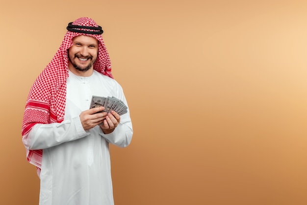 arab-man-businessman-in-national-clothes-rejoices-in-dollars-in-his-hands-great-profit_99433-5...jpg